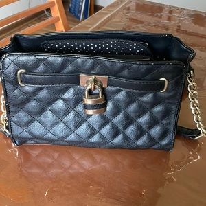 Black leather purse with gold detail.